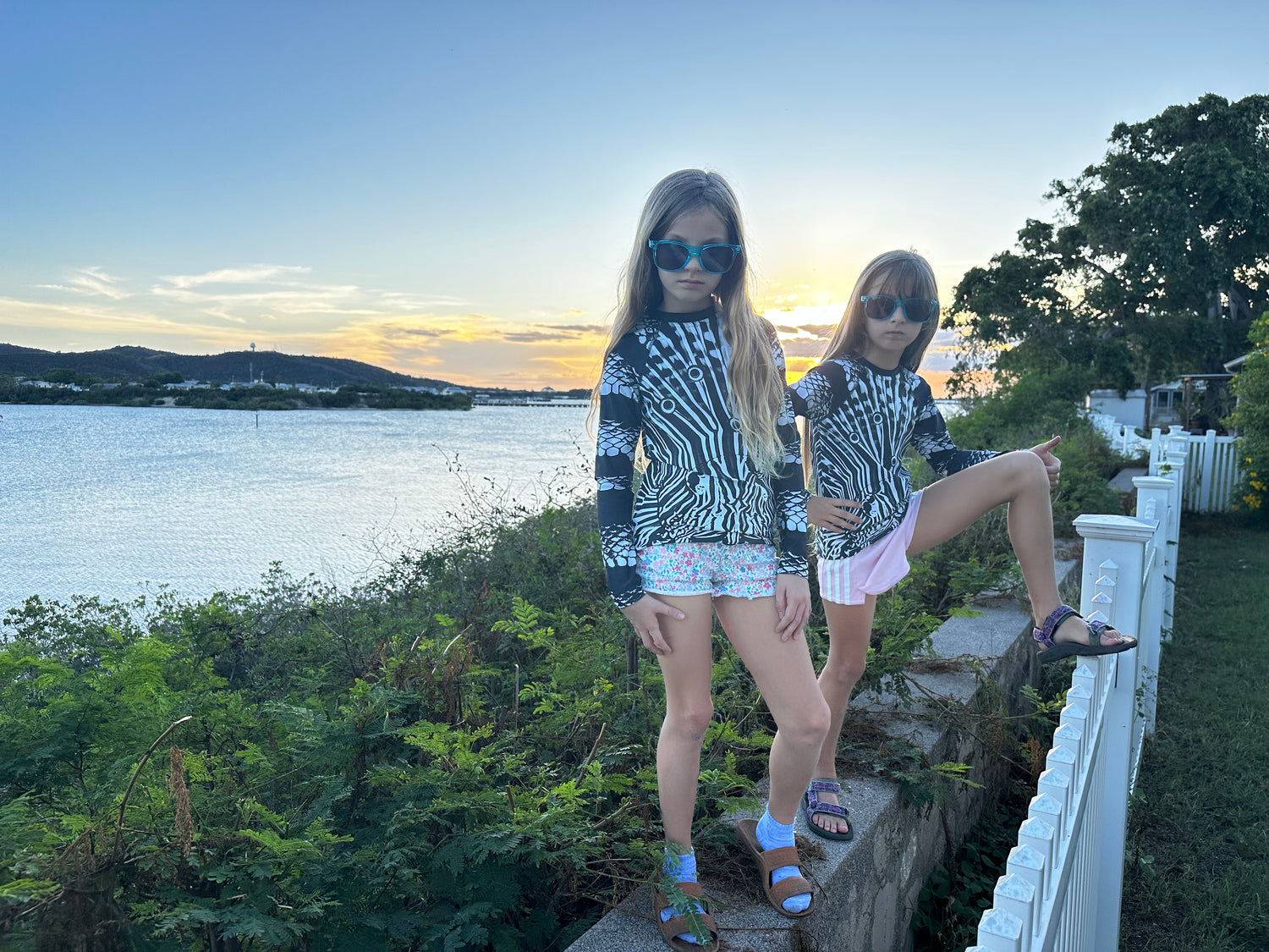 Girls wearing UPF 50 rashguards for sun (and shark) protection : safe beach fun!